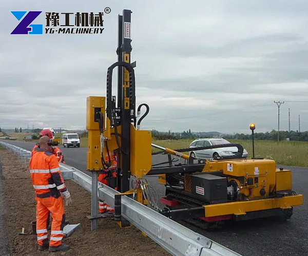 Highway guardrail pile driver at work